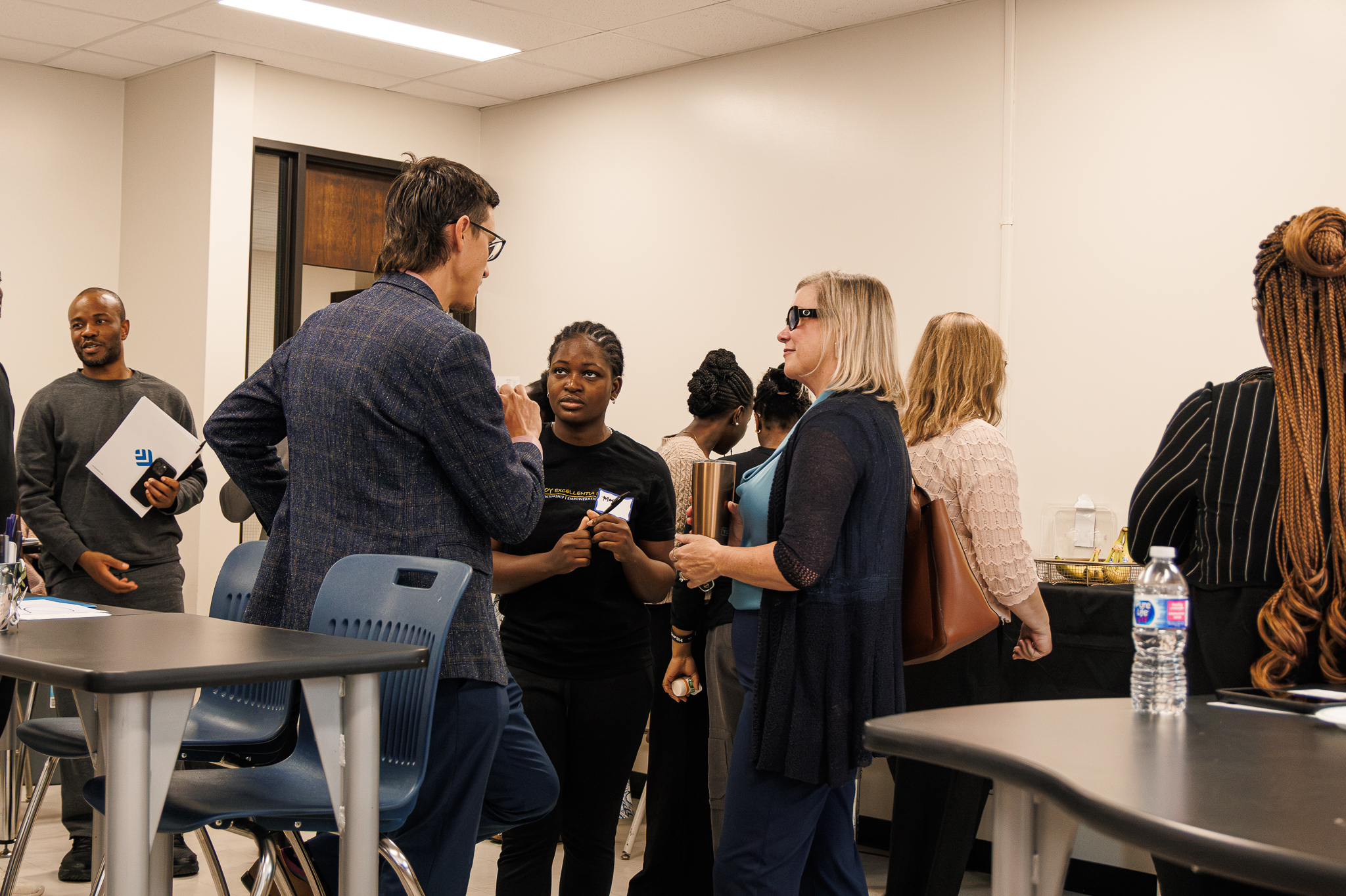 Students networking and speaking with facilitators during the Loy Excellentia Beyond the Classroom professional development workshop at Brandon University.