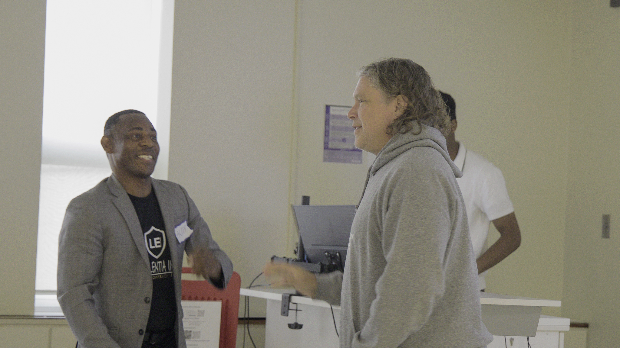 Brandon Mayor Jeff Fawcett speaks with Dr. Aloy Anyichie during the Loy Excellentia workshop at Brandon University.