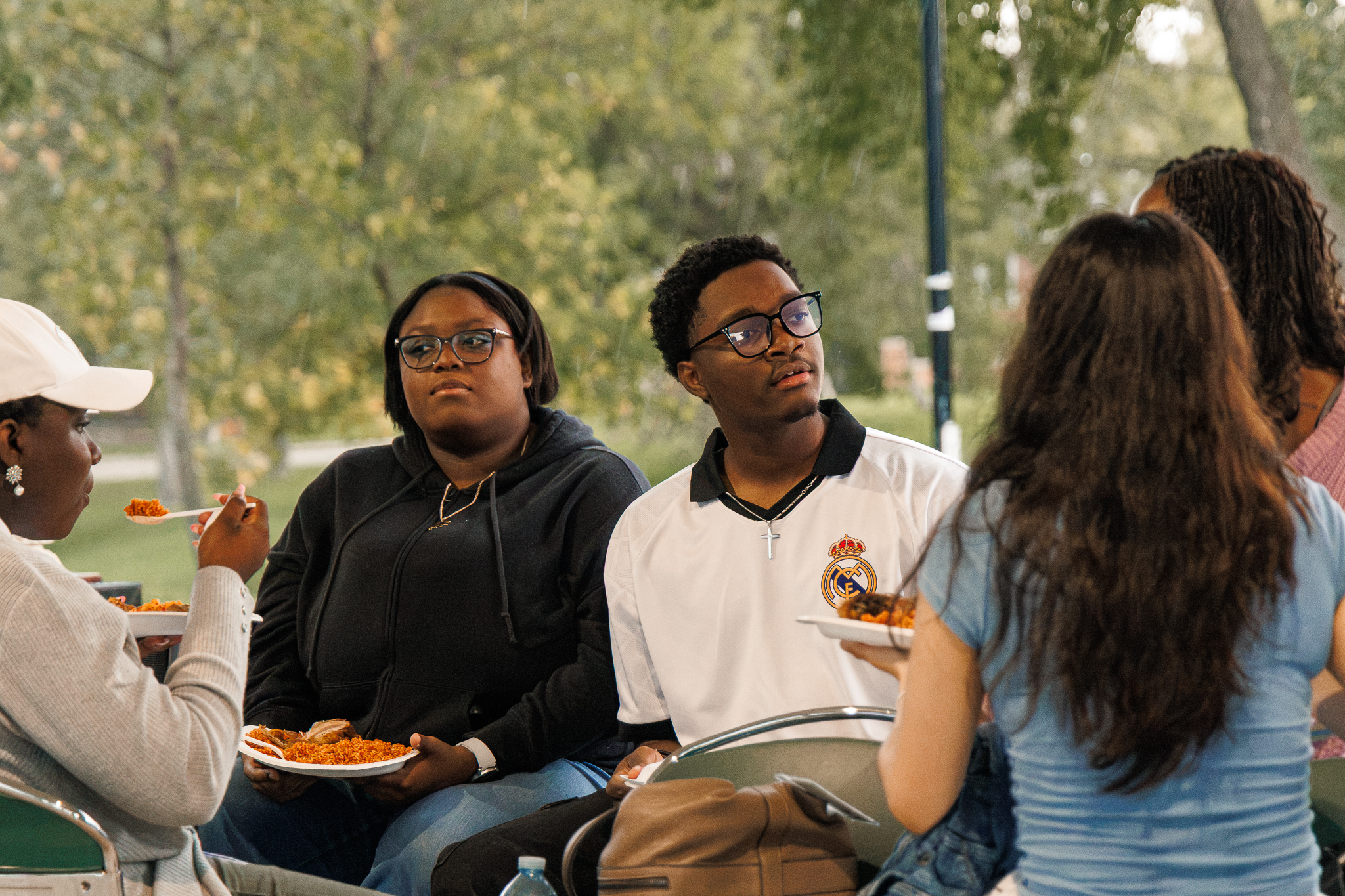 A small group of students eating and socializing together at the 2026 Loy Excellentia Picnic in Brandon, Manitoba.